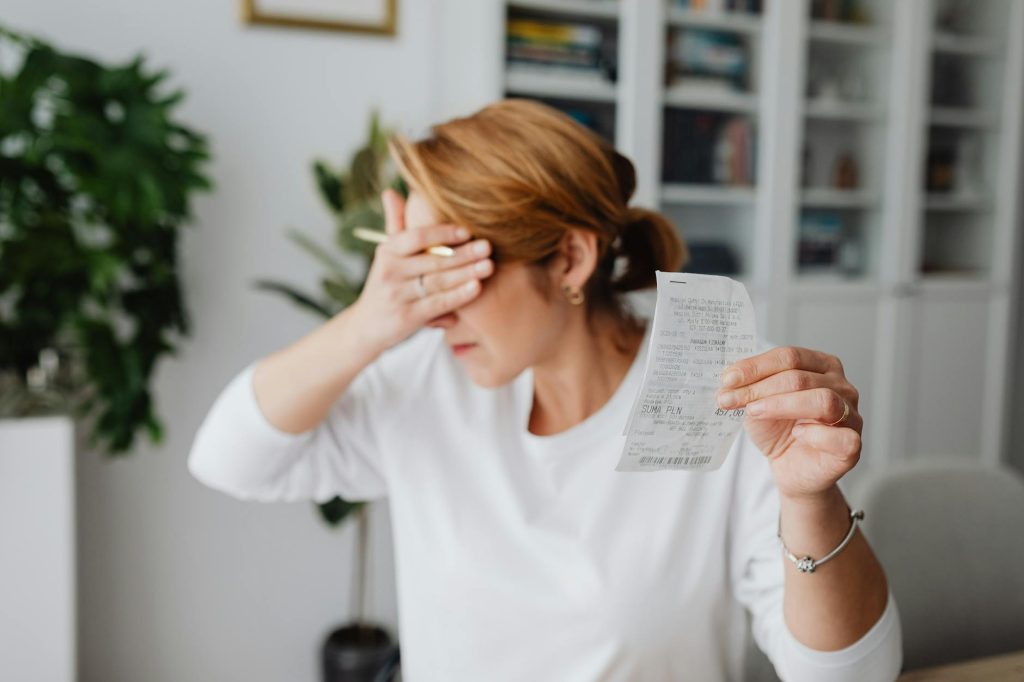 pexels-photo-5900075-5900075 - MIEUX AGIR Woman experiencing stress while reviewing household expenses at home.