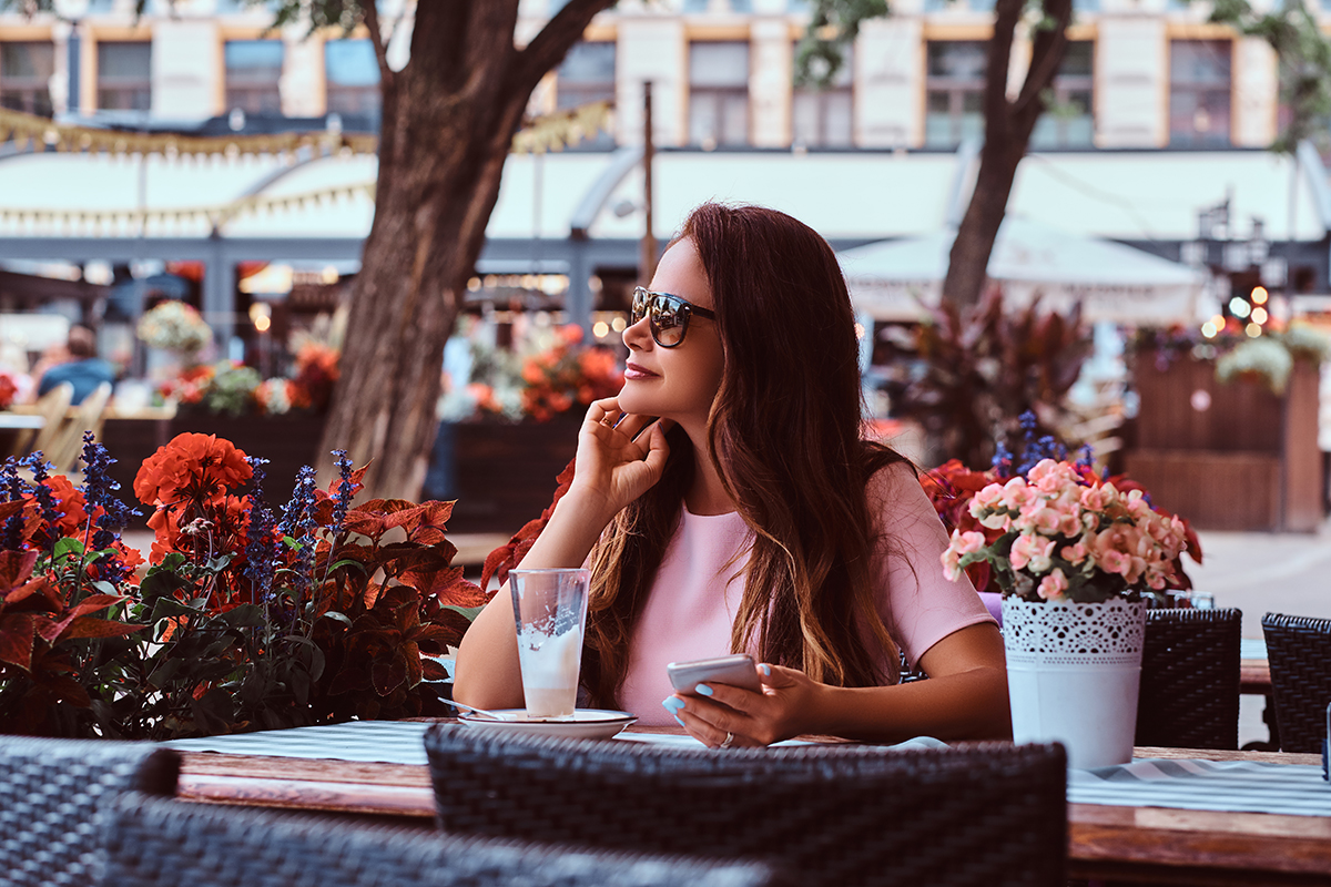 Une terrasse de café parisienne animée sous un soleil de canicule, illustrant les mesures de restriction d'alcool.